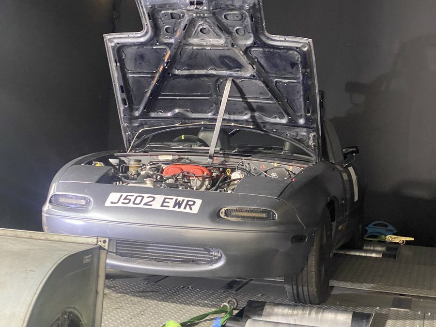 Turbocharged Mazda MX-5 track car strapped down on a rolling road dyno