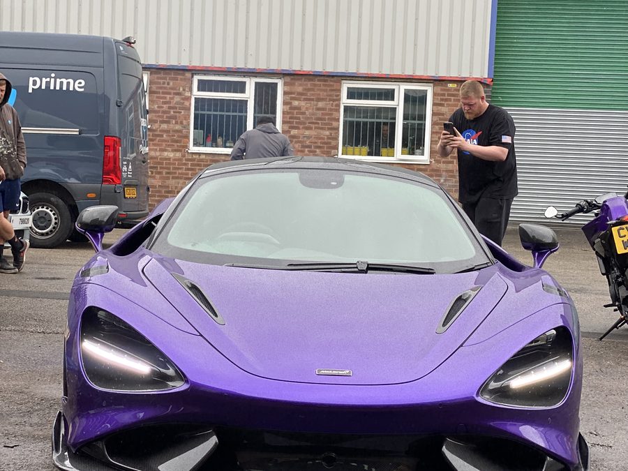 Purple McLaren 720S parked outside the workshop