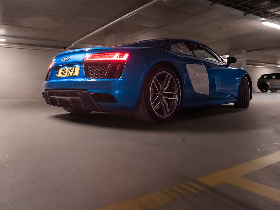 Blue Audi R8 V10 Plus photographed from the rear in an underground car park