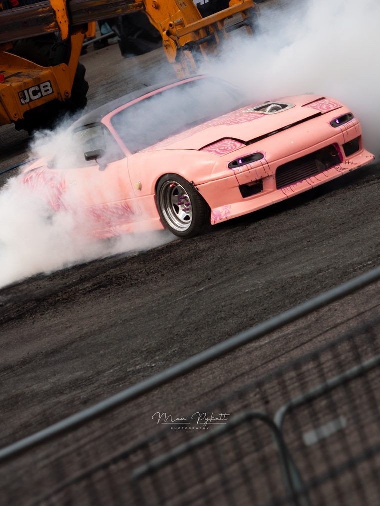 Lewis's pink Mazda MX-5 doing a burnout in front of the crowd at Ultimate Street Car 2025, Santa Pod